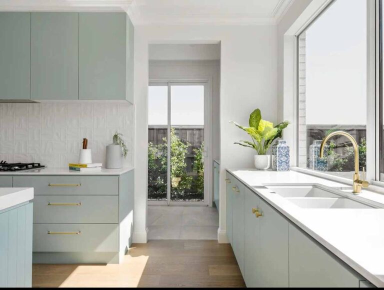 Scandi style kitchen with pastel green cabinets, gold hardware, white countertops, large windows, and abundant natural light. Kitchen Bargains, Creative Style Kitchen Design: Innovative Ideas for Melbourne Homes